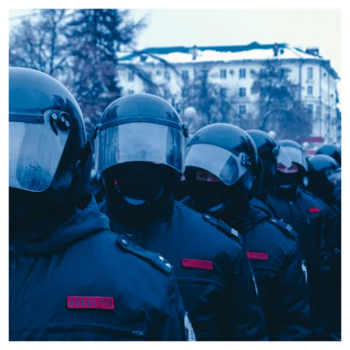 Military/Enforcement: a line of police wearing riot gear