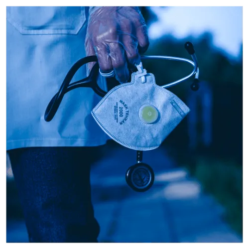 Medicine: a doctor holding their stethoscope and mask